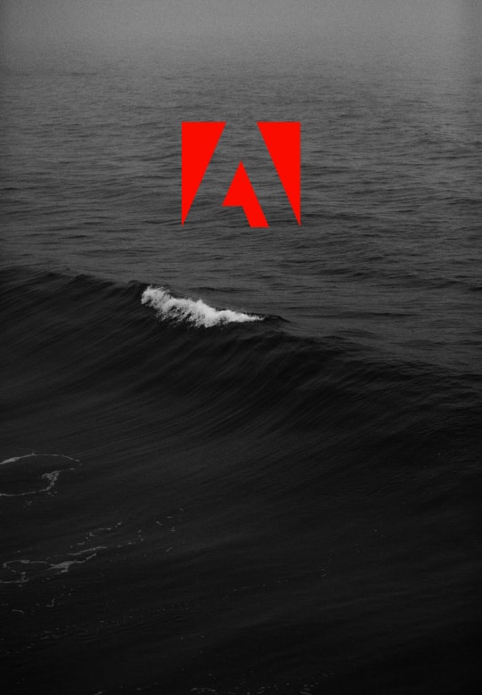 black and white image of wave with adobe logo